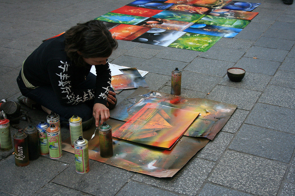 Woman doing spray-paint art outdoors