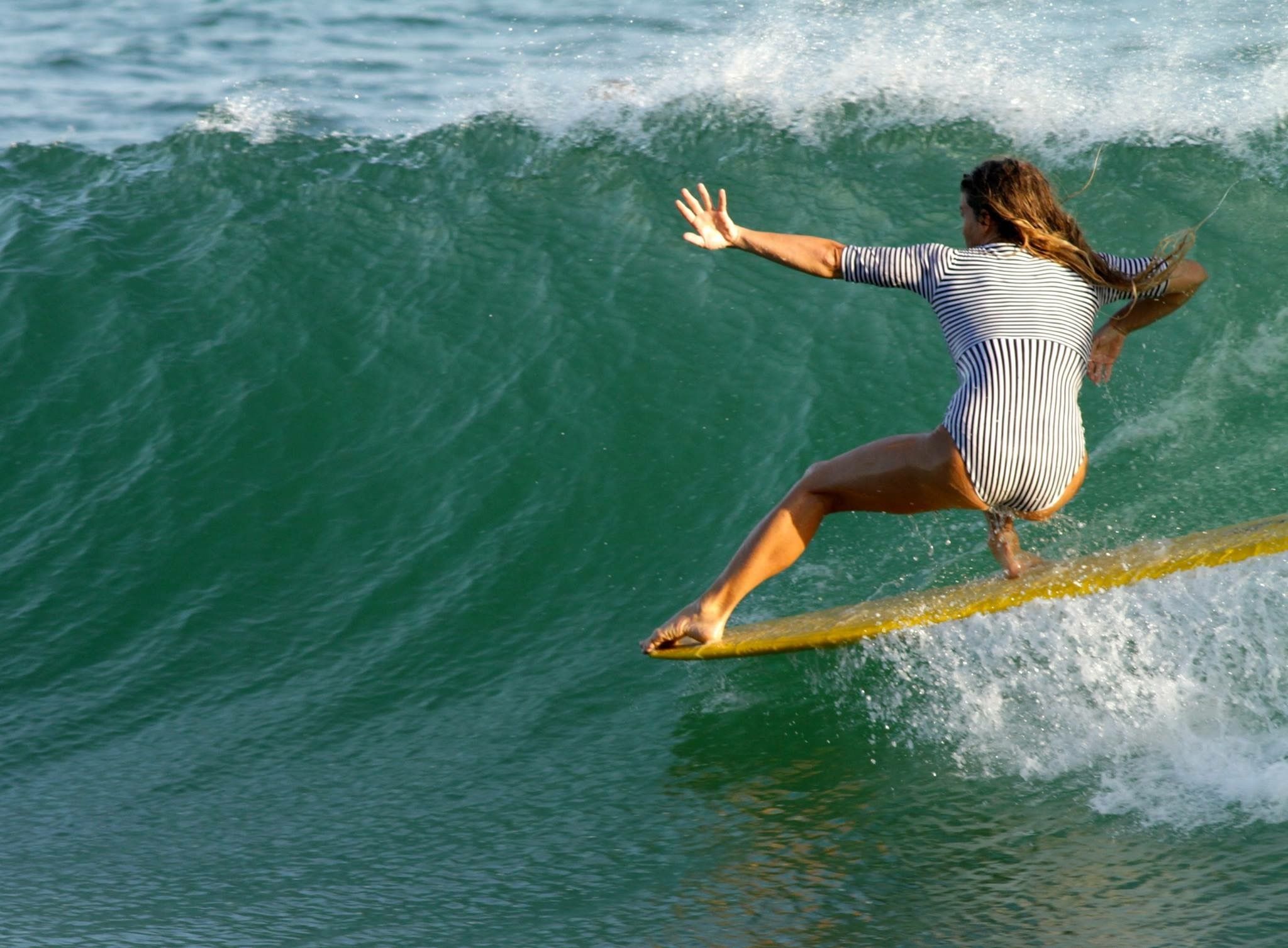 Girl surfing a small-medium wave