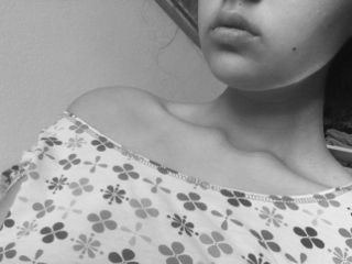 Female shirt draped low enough to highlight her collar bones.