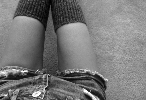 Female wearing stockings sitting down with a thigh gap.