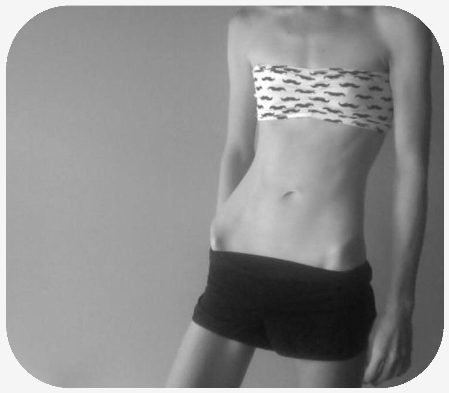 Front view of woman in a skirt with prominent hip bones