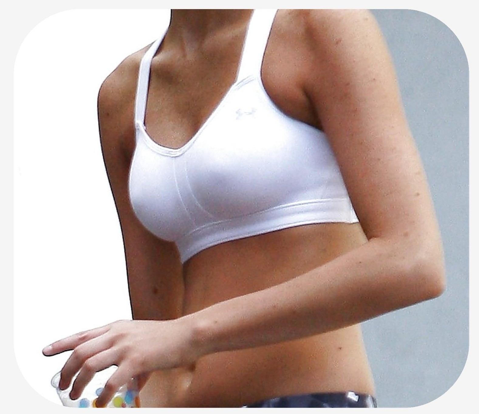 Female wearing a tank top in which large areola outlines are visible through clothing