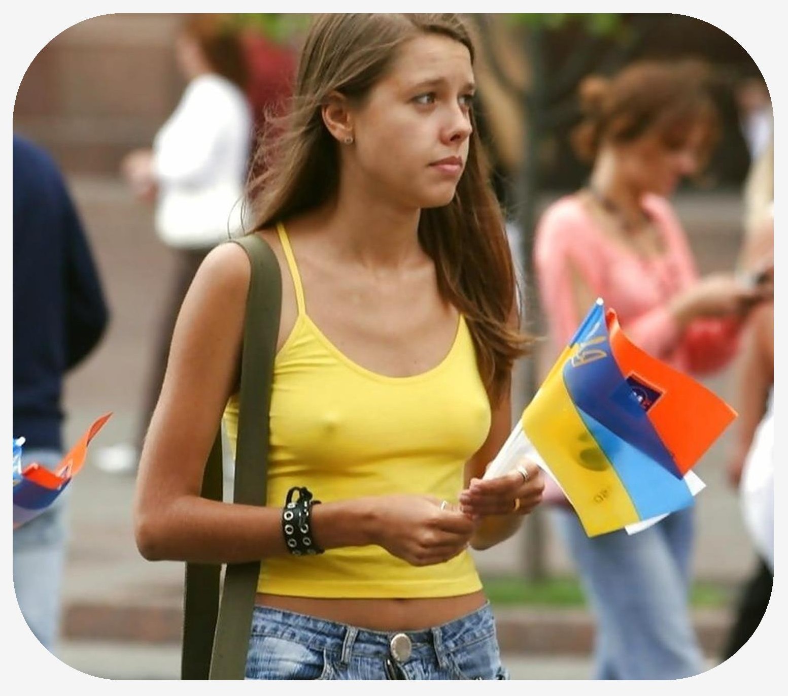 Female who is not wearing a bra walking down the street with nipples visible through her shirt.
