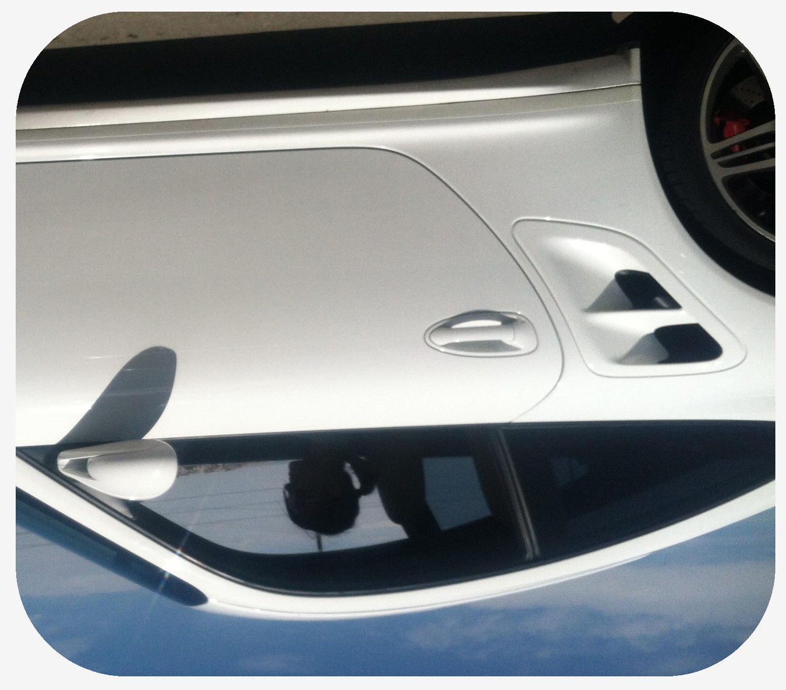 Female with a ponytail driving an white exotic sports car with the windows down