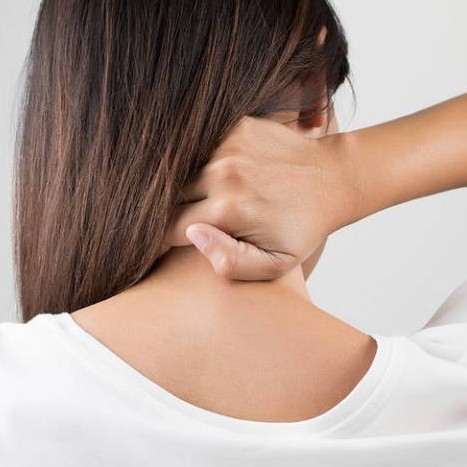 Woman grabbing neck from tension or pain