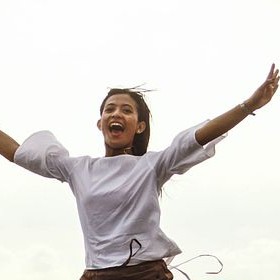 Woman jumping in the air with true joy