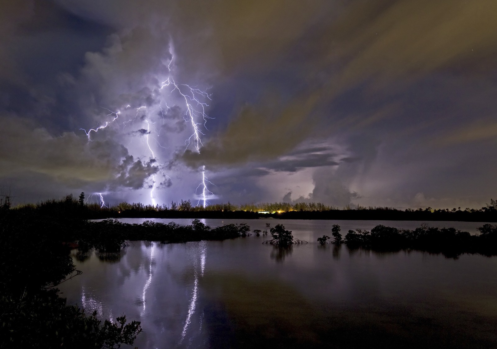 Night lightning storm across a lake