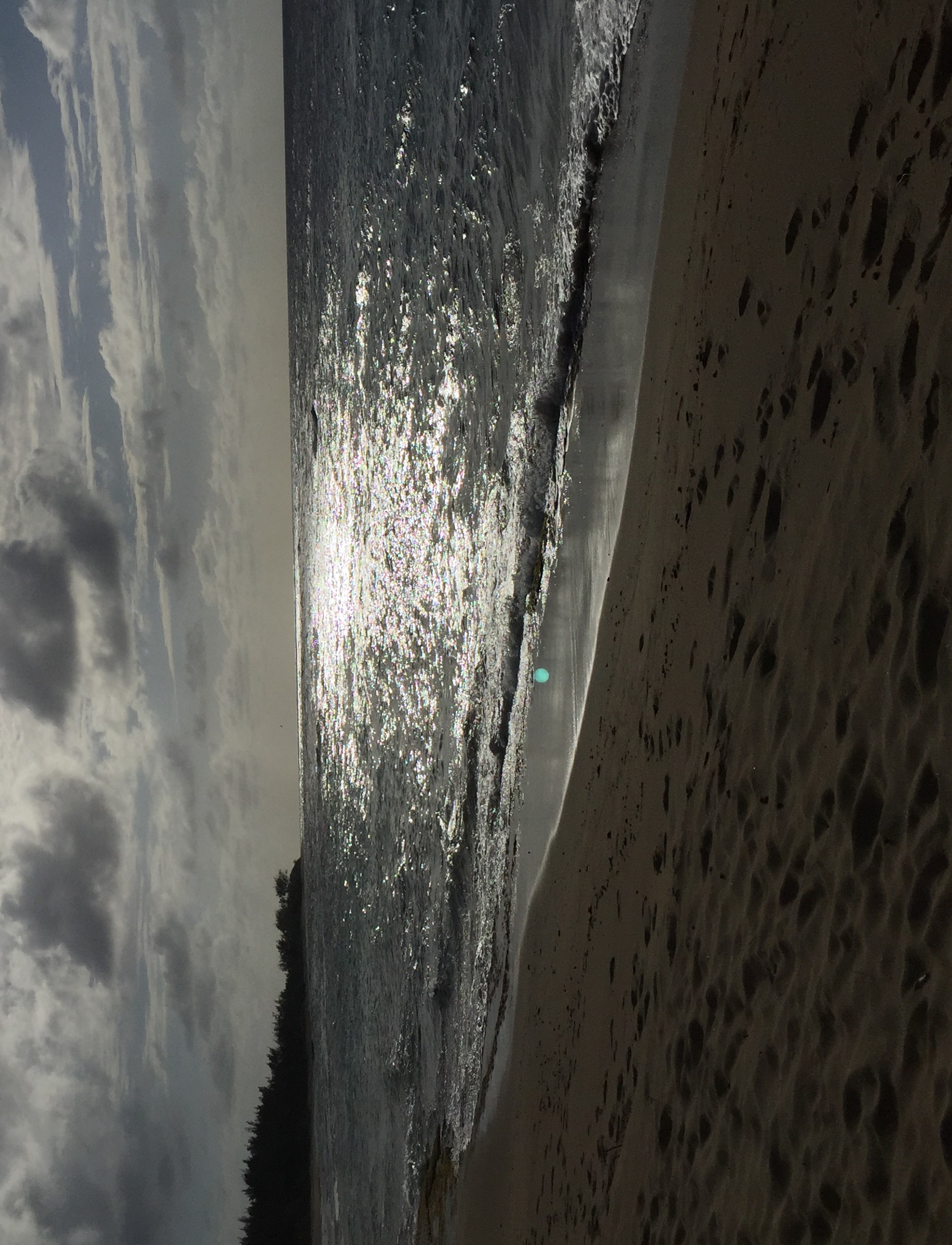 Beach with footsteps in the sand after dusk