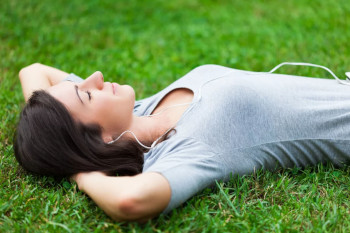 Woman laying in the grass on her back